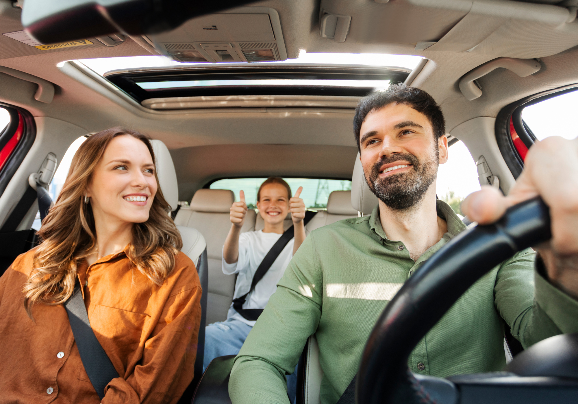 Happy family enjoying a drive in their new SUV.
