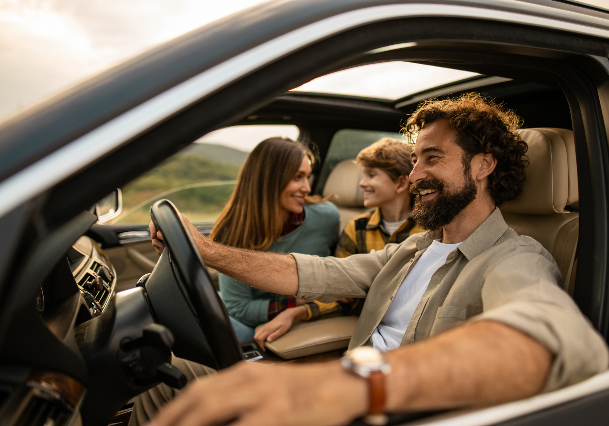 Group of friends driving a recently purchased used car from Enterprise Car Sales.