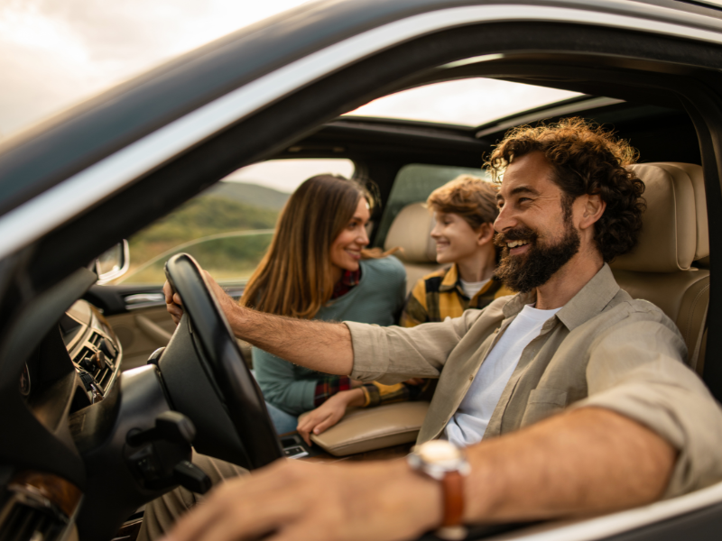 Group of friends driving a recently purchased used car from Enterprise Car Sales.