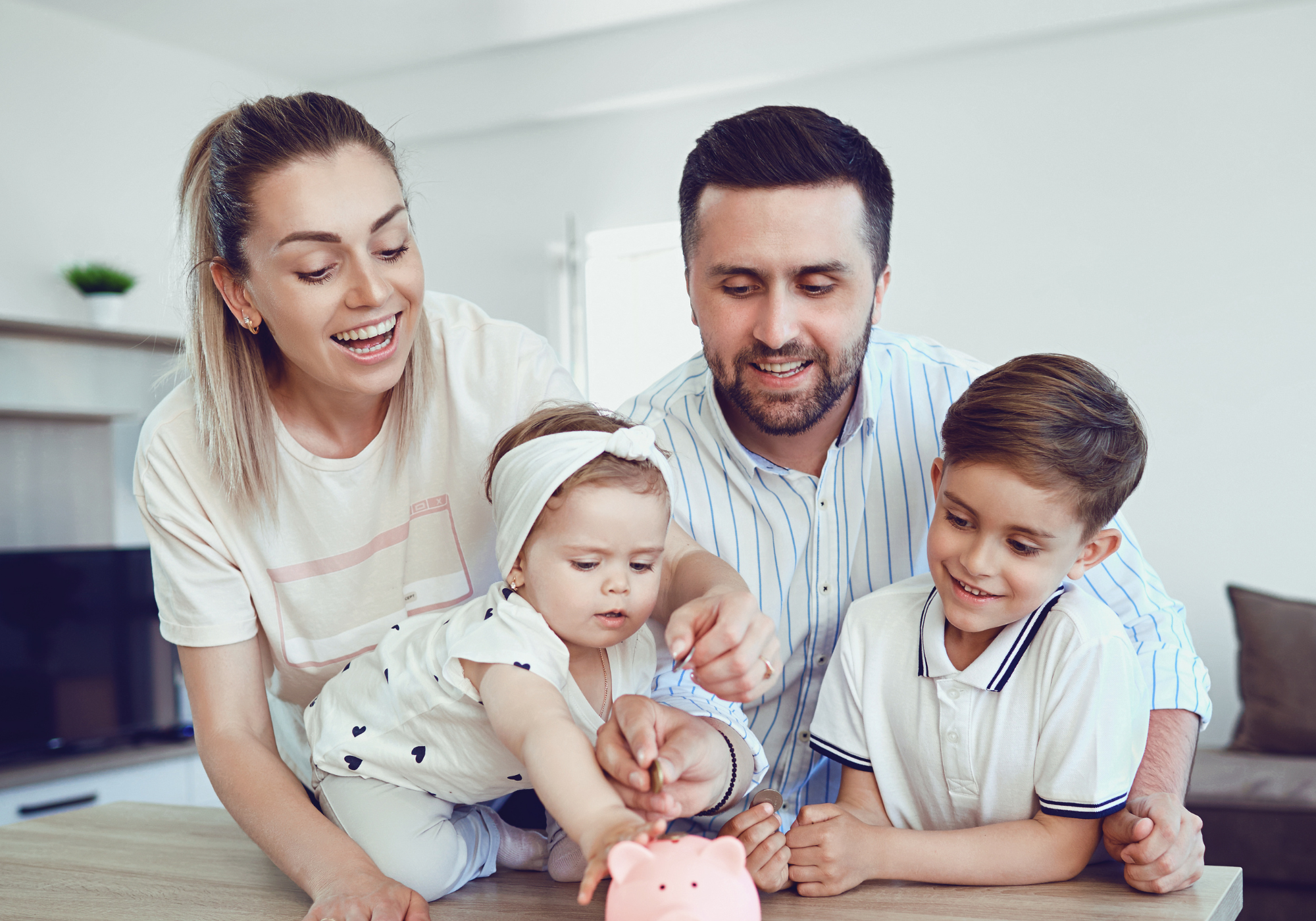 Parents teaching young children how to build an emergency fund.